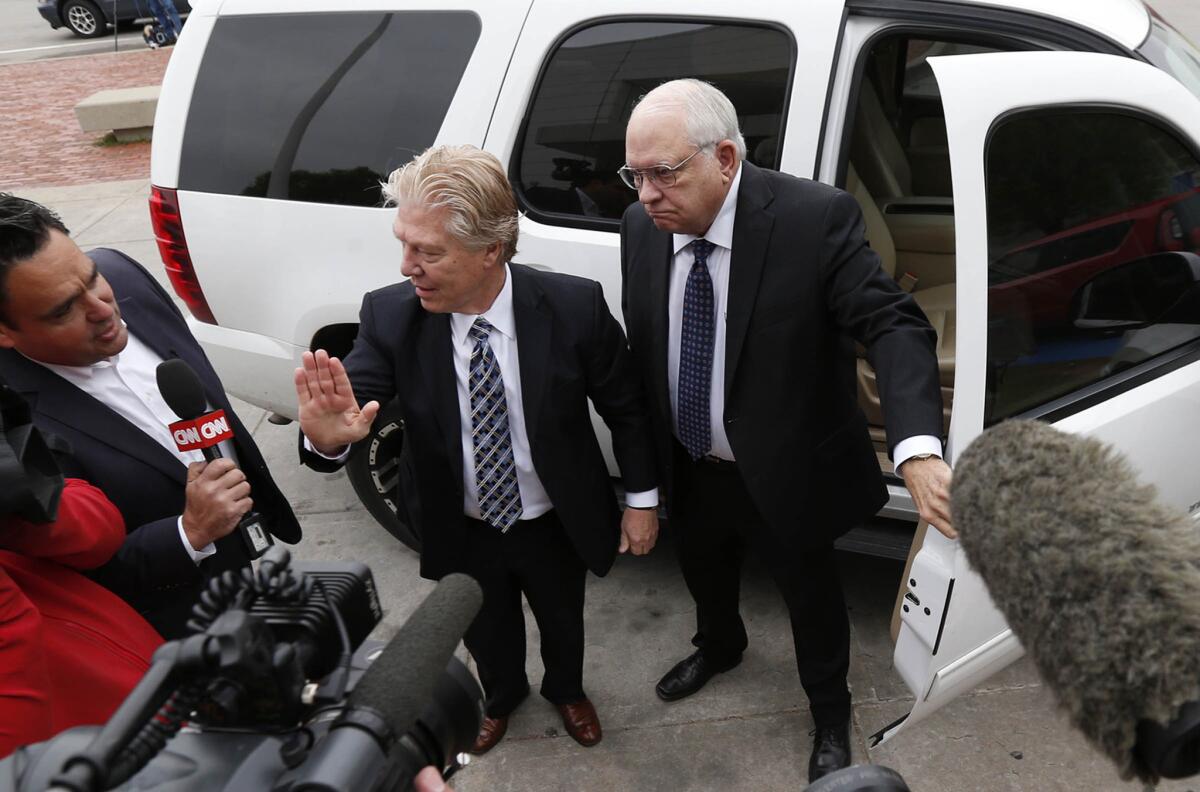 Reserve sheriff's deputy Robert Bates, right, arrives at the Tulsa County Jail with his attorney, Clark Brewster, in Tulsa, Okla. Bates is charged with manslaughter in the shooting death of a suspect.