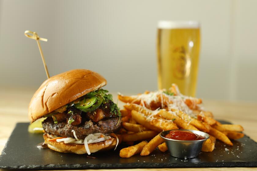 VIsta, CA - May 21: May 21, 2024: Banh Mi burger with Kairi Japanese Lager at Prey Brewing Co. in Vista, CA on May 21, 2024. (K.C. Alfred / The San Diego Union-Tribune)