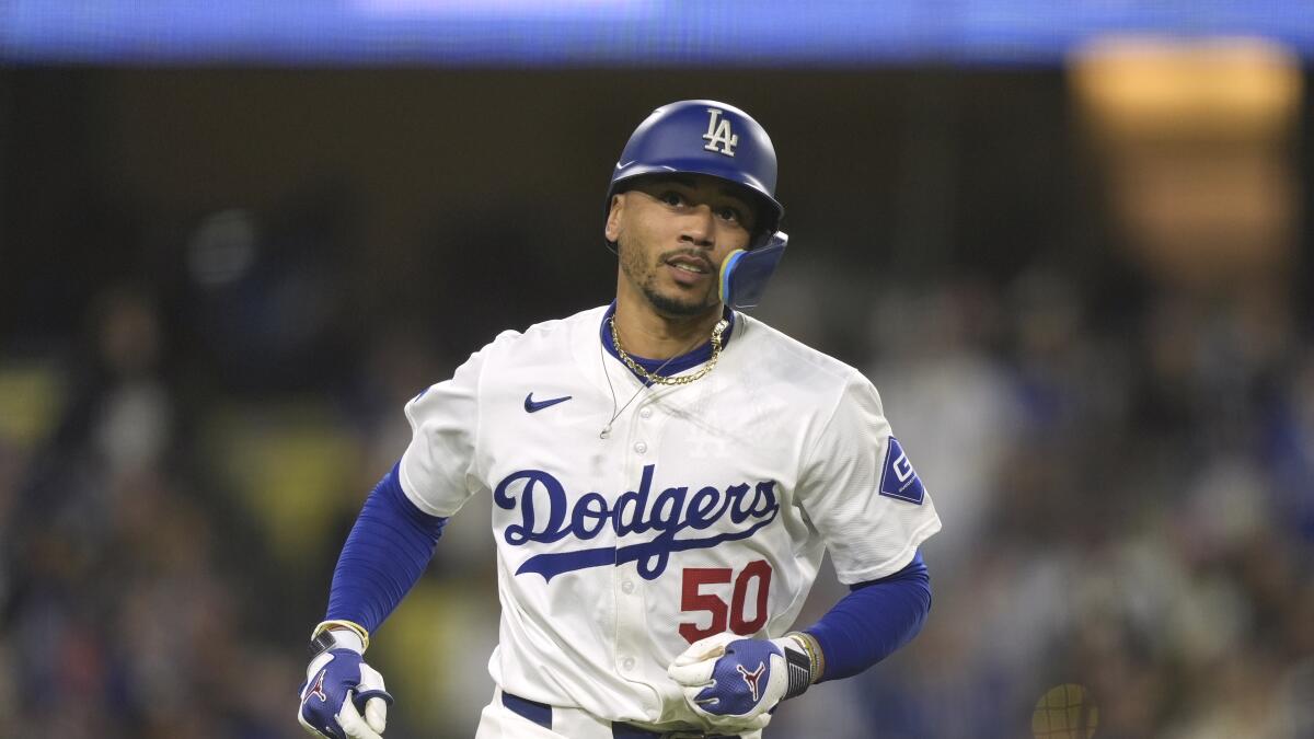 Los Angeles Dodgers' Mookie Betts runs to first base during a baseball game.