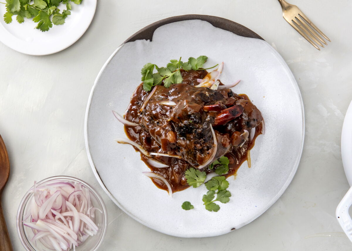 Brown sugar and raisins to add sweetness to the sauce for Sticky-Sour Tamarind Lamb Shanks.