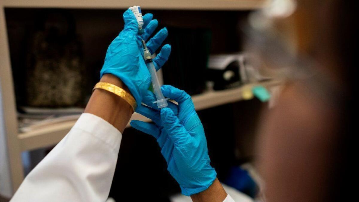 A nurse prepares the measles, mumps and rubella vaccine at the Rockland County Health Department in New York.