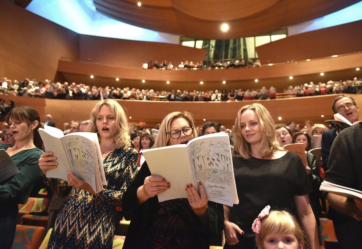 Audience members sing along with Los Angeles Master Chorale in a performance of Handel's Messiah at Walt Disney Concert Hall.