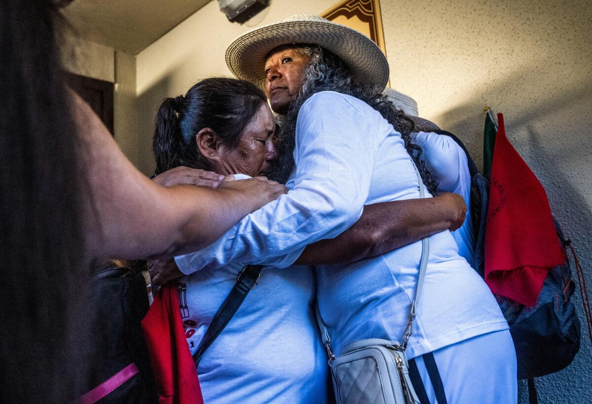 United Farm Workers President Teresa Romero, right, embraces Teresa Maldonado Mendoza