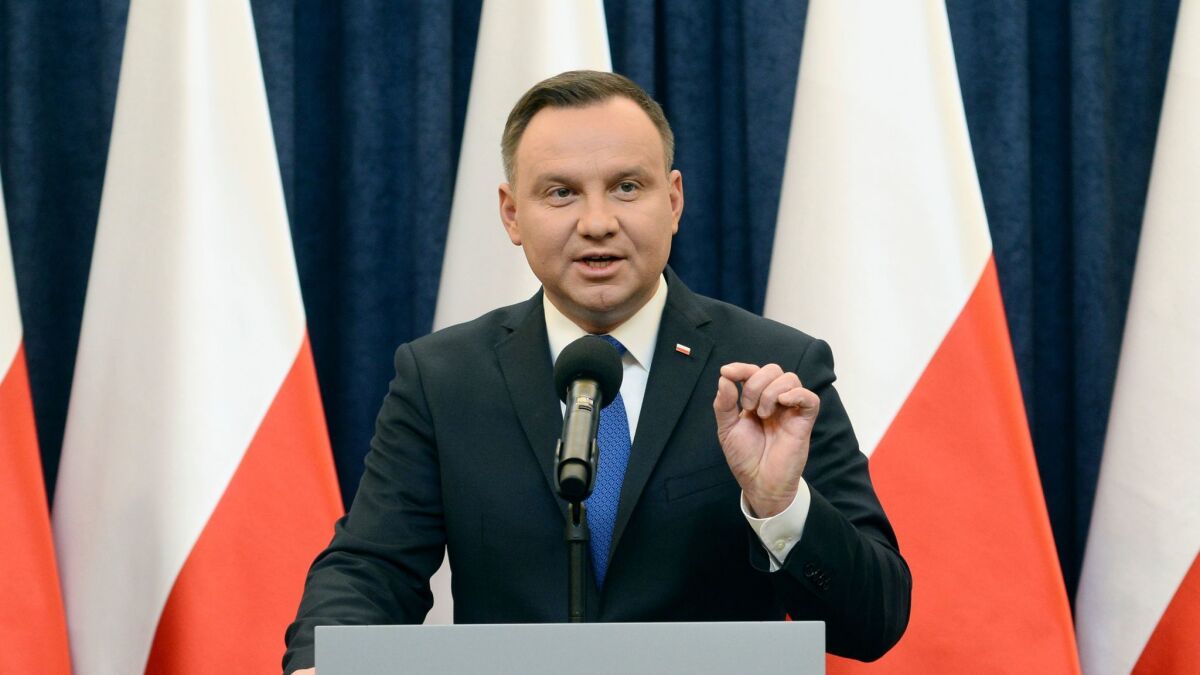 Polish President Andrzej Duda announces his decision to sign a legislation penalizing certain statements about the Holocaust, in Warsaw on Tuesday.