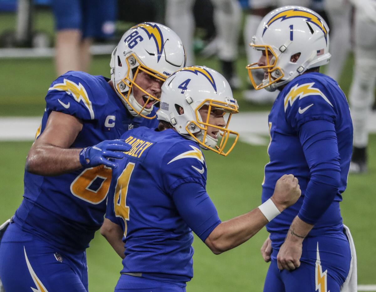Chargers kicker Mike Badgley celebrates with Hunter Henry, left, and Ty Long after hitting a 43-yard field goal.