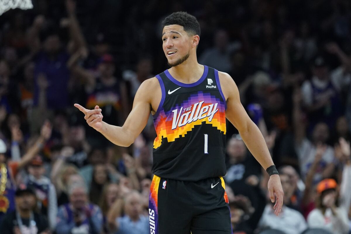Phoenix Suns guard Devin Booker (1) reacts to a play against the Dallas Mavericks during the second half of Game 1 in the second round of the NBA Western Conference playoff series Monday, May 2, 2022, in Phoenix. (AP Photo/Matt York)