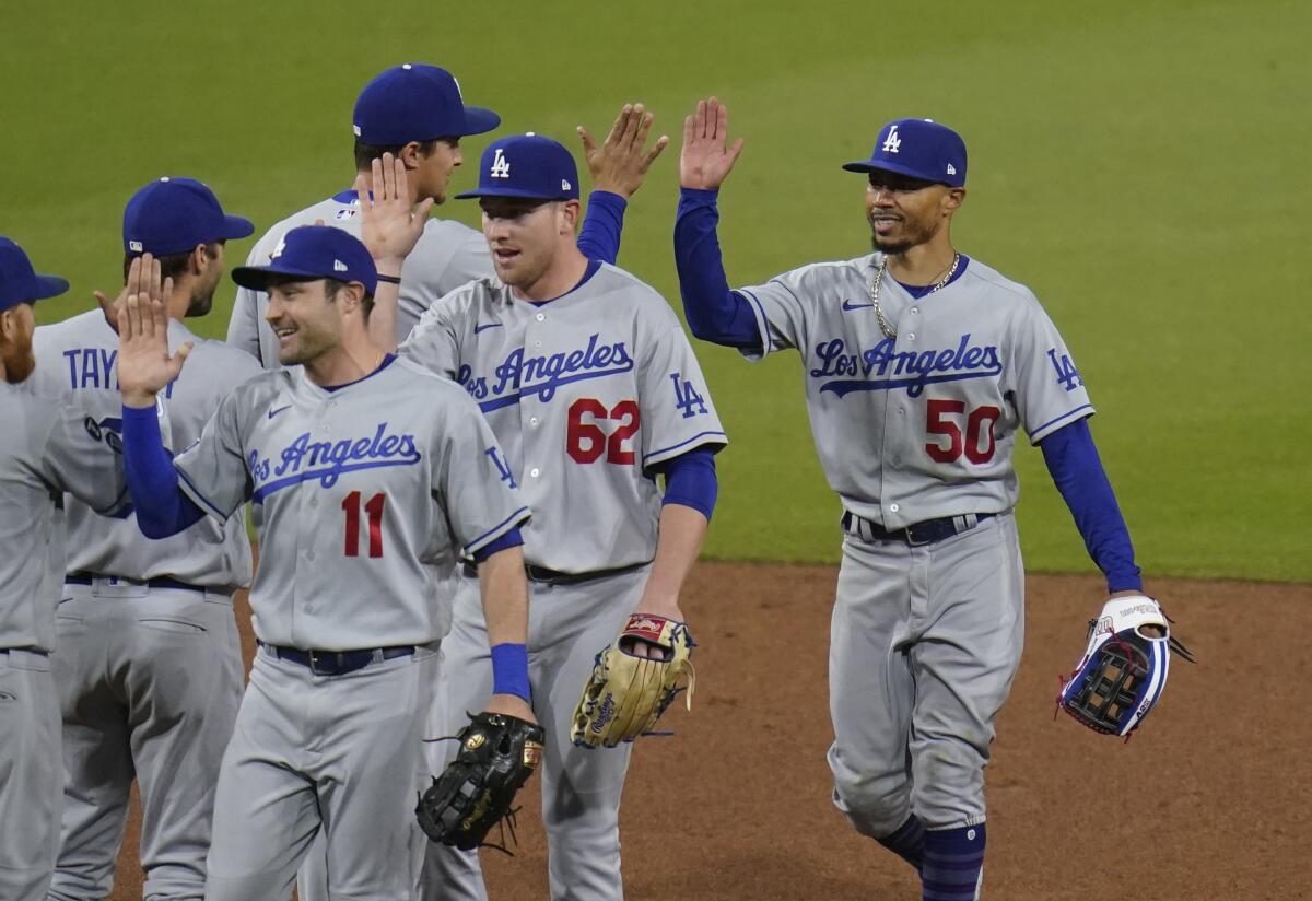 Dodgers celebrate after their victory Saturday.