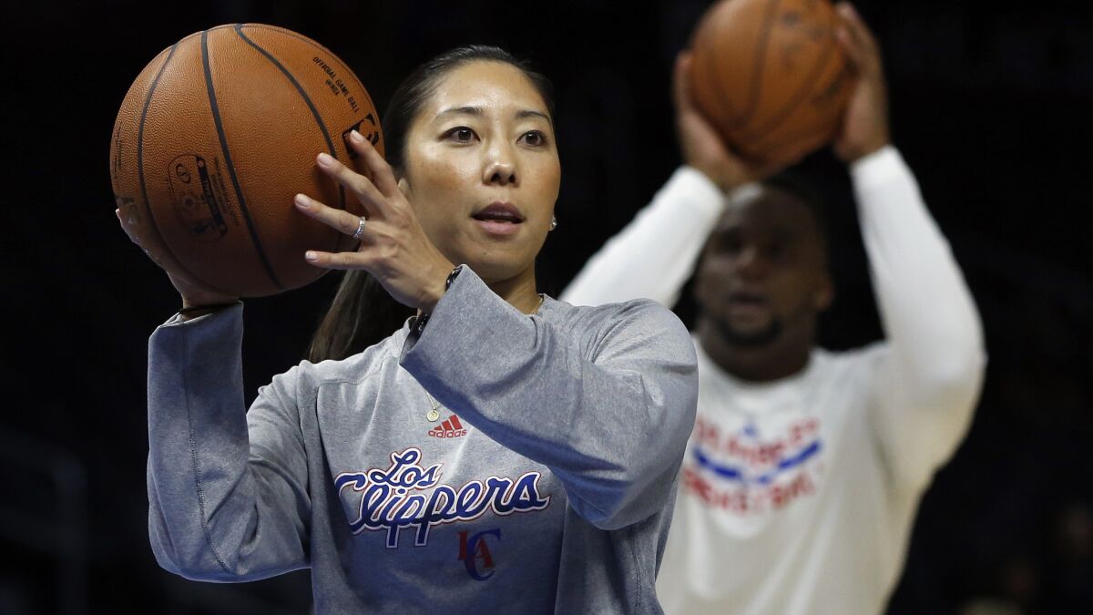Clippers video coordinator Natalie Nakase assists players during warmups before a game against Dallas Mavericks on Jan. 10.
