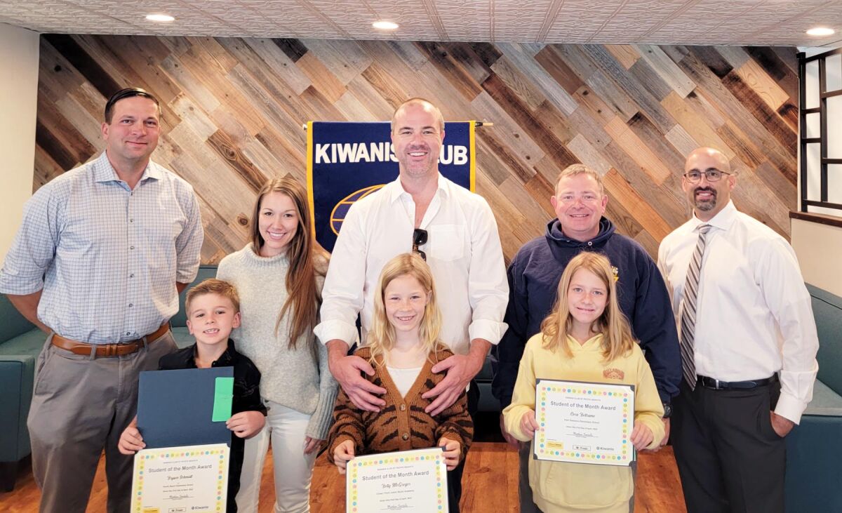 Students Brysen Schmidt, Betty McGregor and Cora Beltrano with their parents and PB Kiwanis Club President-elect Tony Bayona.