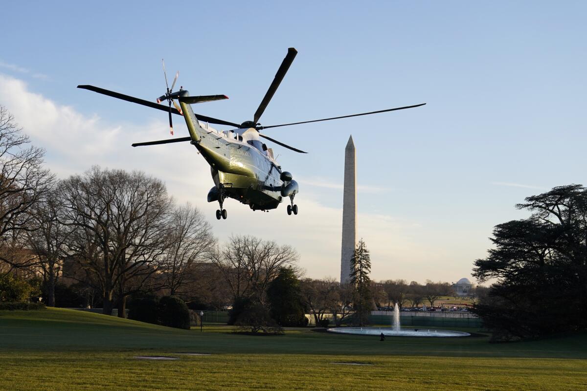 Presidential helicopter Marine One lifts off from the White House grounds, with the Washington Monument in the background.