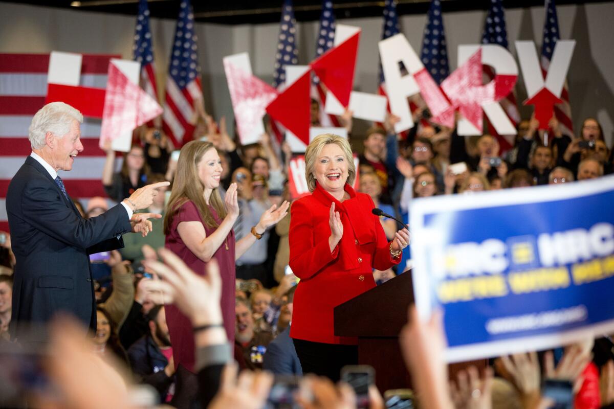 Democratic presidential candidate Hillary Clinton, accompanied by former President Bill Clinton and their daughter Chelsea Clinton, arrives onstage at her caucus night rally at Drake University in Des Moines, Iowa.