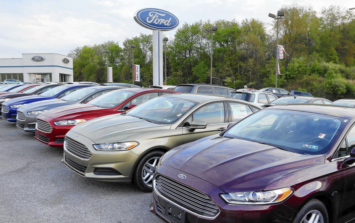 Automakers reported big sales numbers in July amid a wave of increasing consumer confidence. Above, 2013 Ford Fusions on the lot of a dealer in Zelienople, Pa.