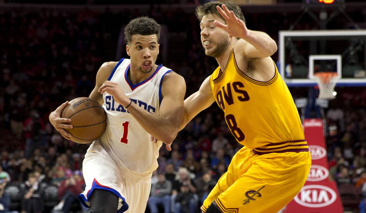 76ers point guard Michael Carter-Williams drives to the basket against Cavaliers point guard Matthew Dellavedova during their game Monday night in Philadelphia.