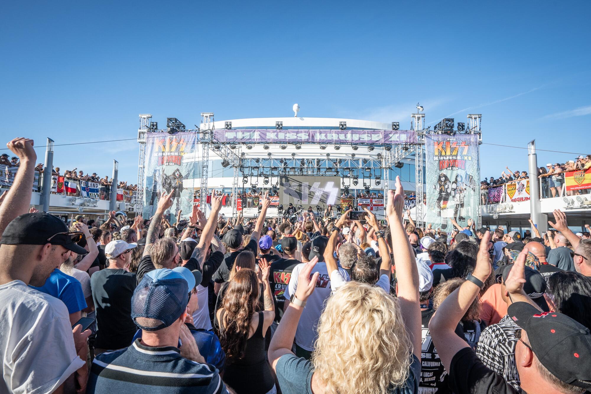 People watch a concert on the Kiss cruise. 