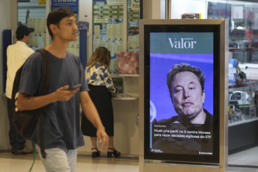 An ad by Valor media shows a photo of Elon Musk at a shopping center in Brasilia, Brazil, Monday, Sept. 2, 2024. The sign reads in Portuguese: "Musk creates profile on X against Moraes to leak confidential decisions of the Supreme Court," referring to Supreme Court Justice Alexandre de Moraes who ordered the platform blocked for having failed to name a local legal representative as required by law. (AP Photo/Eraldo Peres)