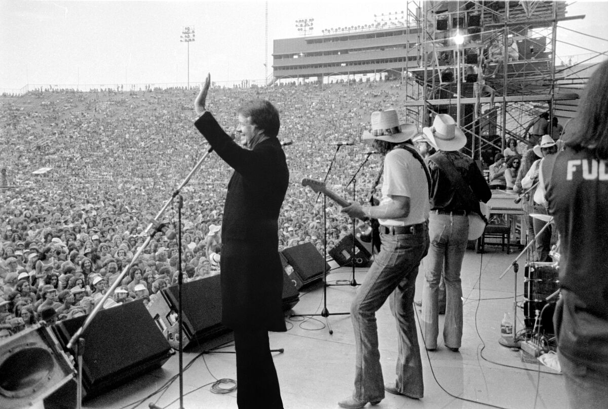 Jimmy Carter onstage with Willie Nelson.