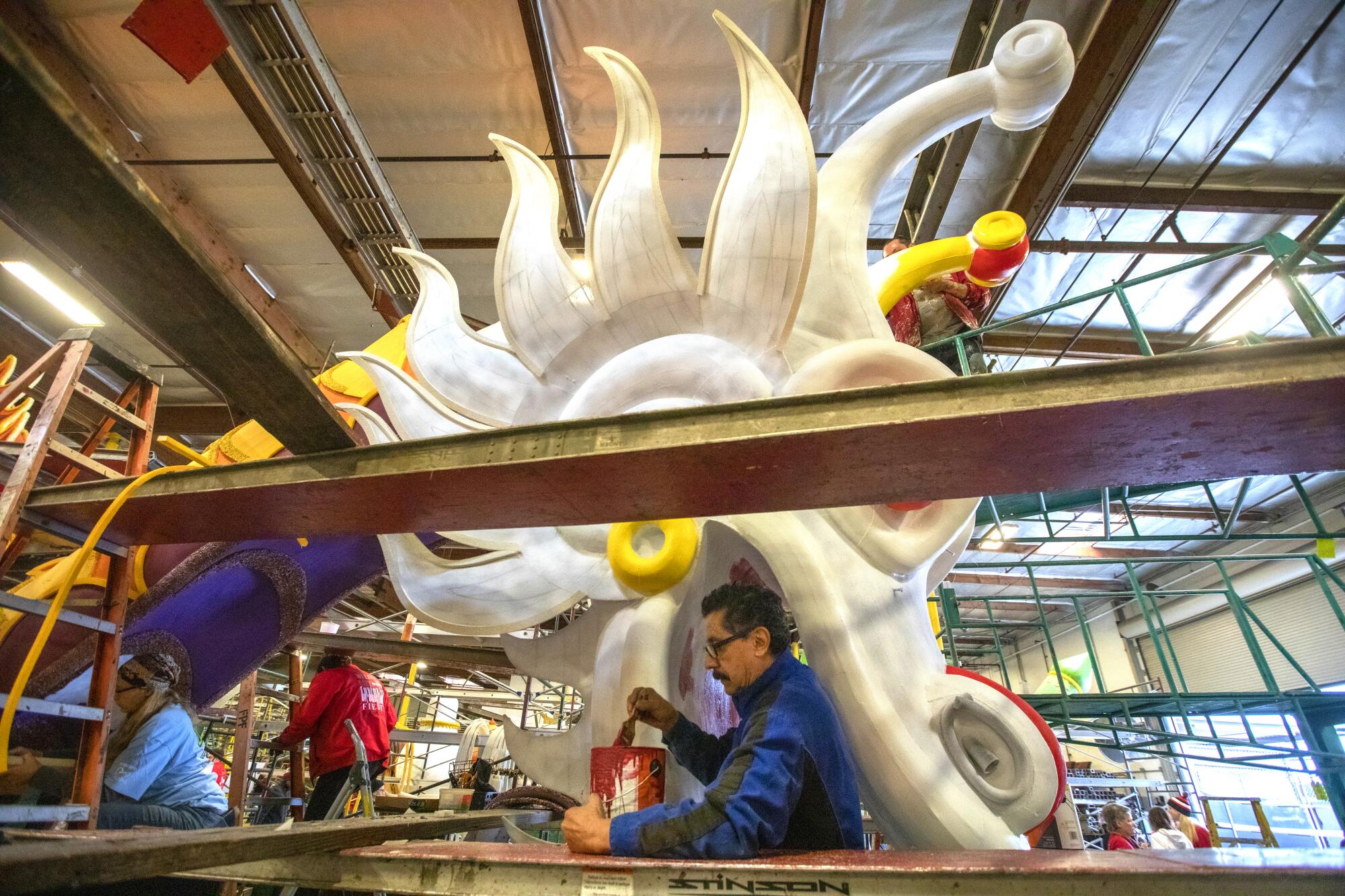 Andres Trujillo works on Donate Life's "Lifting Each Other Up" float.