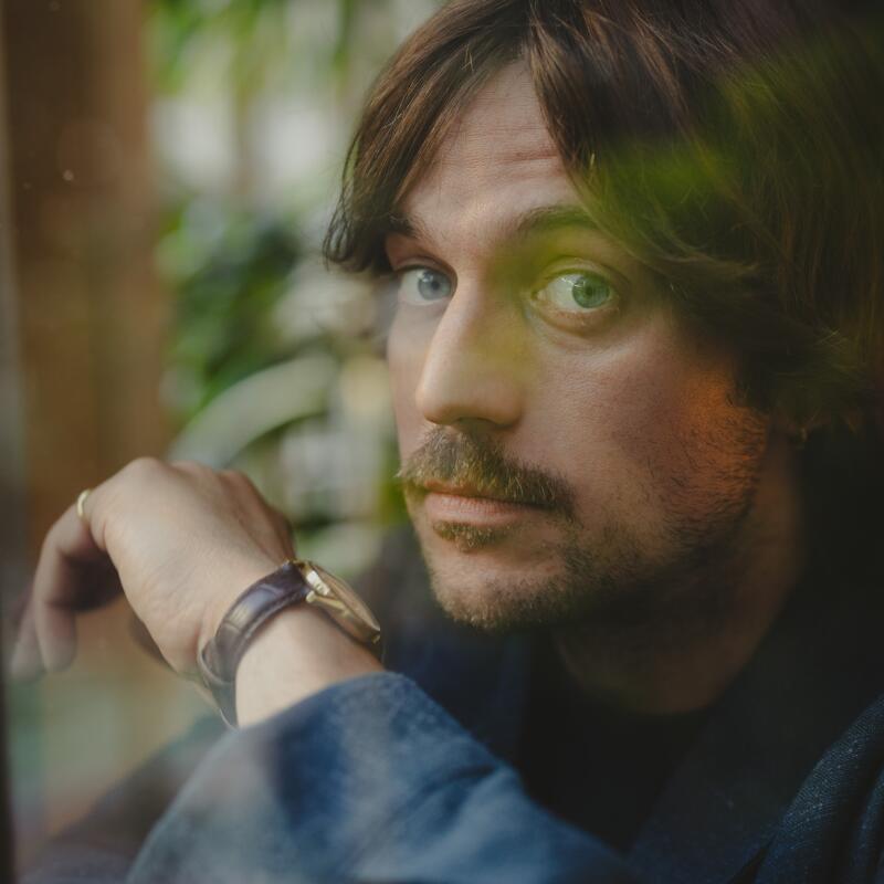 A man in a gray blazer