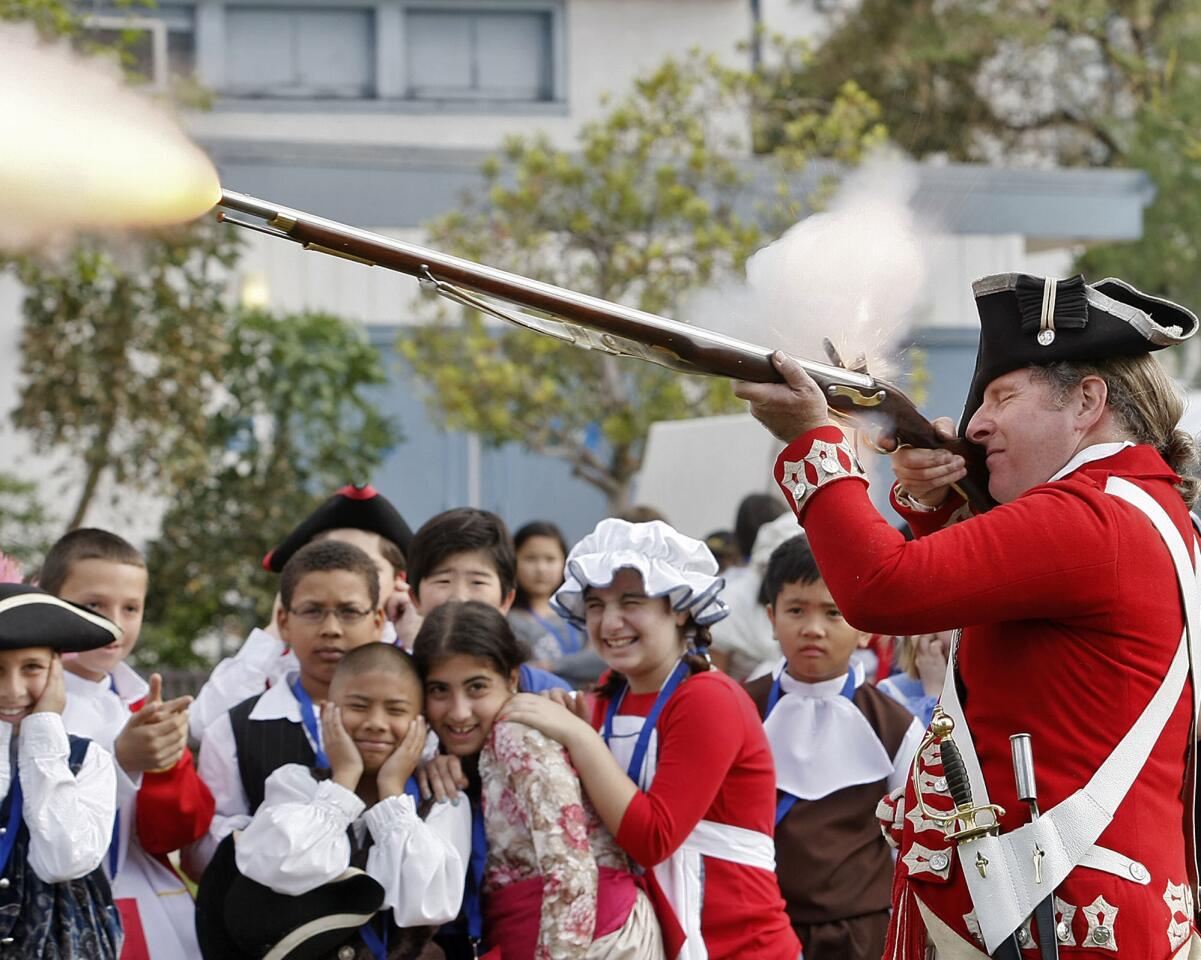 Radford Polinsky, dressed as Sgt. John Savage, fires a blank shot as Keppel Elementary School 5th graders watch during the annual Colonial Days at the Glendale school on Friday, April 5, 2013. Polinsky's uniform is from The Colonel, Lord Cornwallis' Company, The 33rd Regiment of Foot. About 146 students from the five 5th grade classes at the school participated.