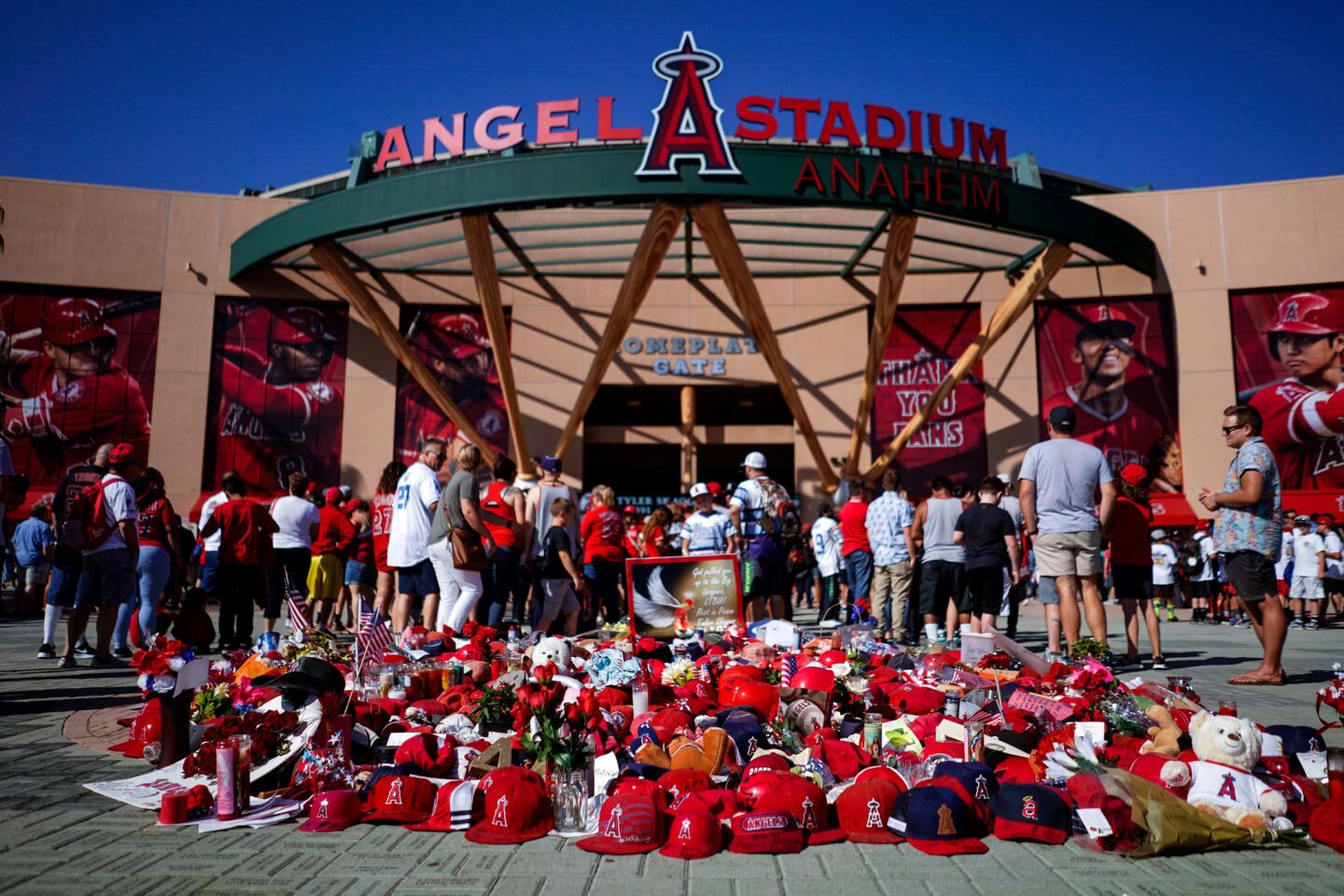 Angel fans look at a memorial for Tyler Skaggs in front of Angel Stadium.