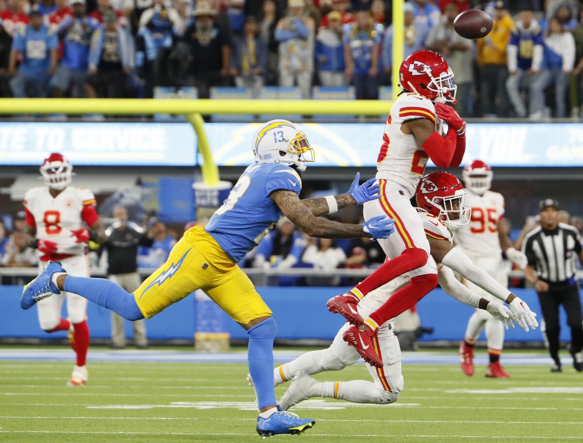 Deon Bush (26) knocks away a pass intended for the Chargers' Keenan Allen and was intercepted by Chiefs teammate Nick Bolton.