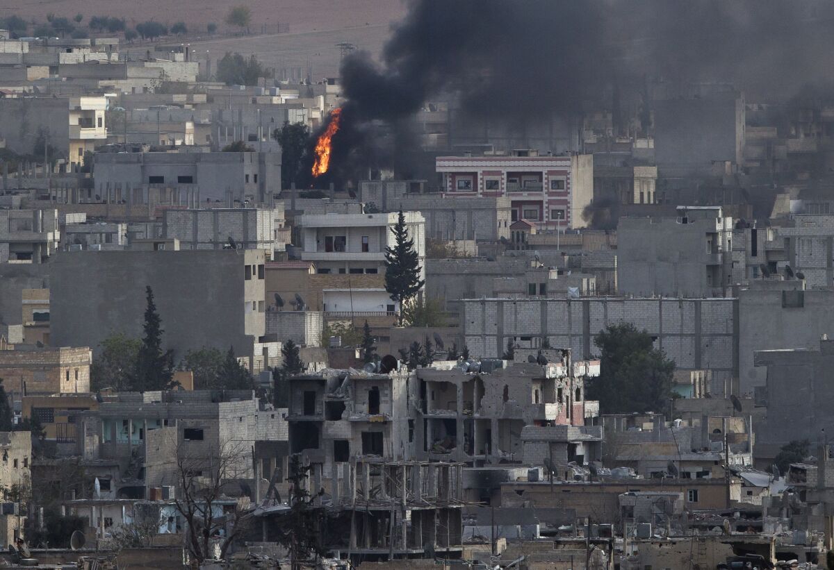 A fire in the Syrian city of Kobani is seen from a hilltop across the border in Turkey, on Nov. 13. Kobani has been under assault by Islamic State extremists since mid-September.