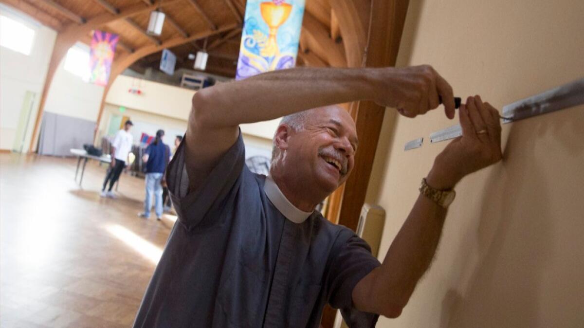 The Rev. Eric Shafer, pastor of Mt. Olive Lutheran Church in Santa Monica, puts the finishing touches on Bruin Shelter, the first homeless shelter for college students run by college students.
