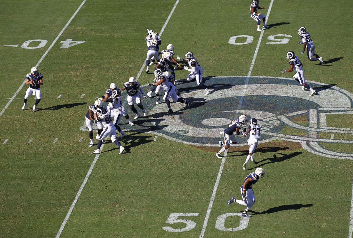 The Chargers run a play against the Rams in L.A. on Sept. 23, 2018. The teams will be featured on "Hard Knocks" in August.