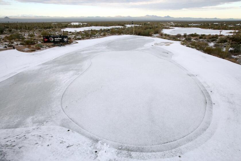 Snow and frost cover the No. 9 green Thursday in Marana, Ariz.