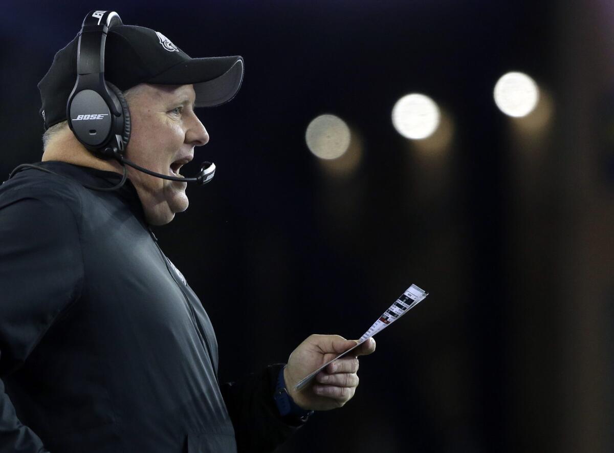 Eagles Coach Chip Kelly watches from the sideline during the first half of a game against the Patriots.