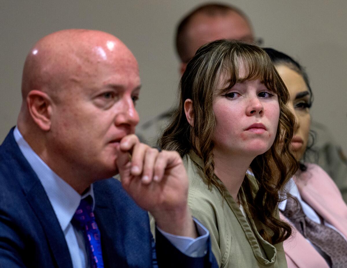 Hannah Gutierrez, center, sits with her attorney Jason Bowles and paralegal Carmella Sisneros. 