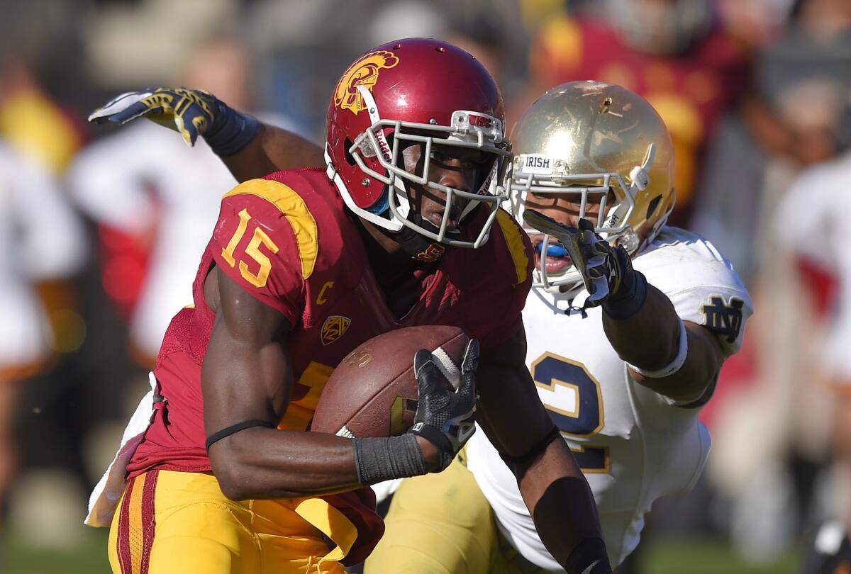 USC receiver Nelson Agholor (15) runs away from Notre Dame safety Elijah Shumate on Saturday at the Coliseum.