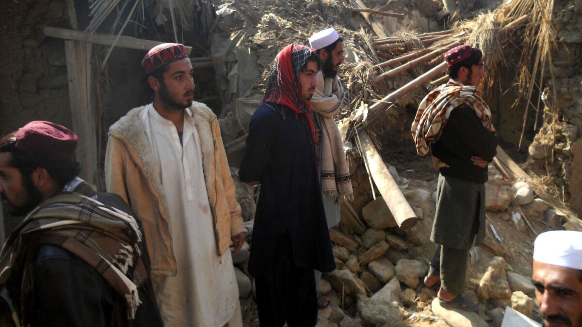 Pakistani students gather at a destroyed religious seminary belonging to the Haqqani network after a U.S. drone strike in the Hangu district of Khyber Pakhtunkhwa province on Nov. 21, 2013.