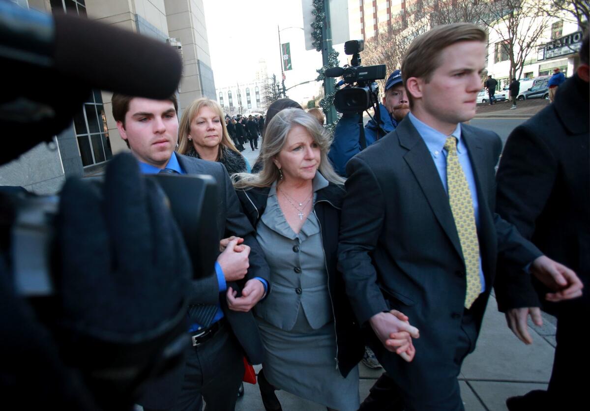 Former Virginia first lady Maureen McDonnell, center, leaves federal court with her sons, Bobby, left, and Sean after her husband, former Gov. Bob McDonnell, was sentenced to two years in federal prison for corruption charges, Tuesday, January 6, 2015, in Richmond, Va.
