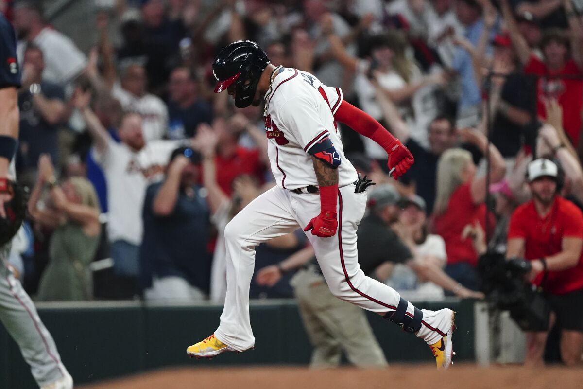 Atlanta Braves' Orlando Arcia reacts as he rounds the bases after hitting a two-run walkout home run in the ninth inning of a baseball game against the Boston Red Sox Wednesday, May 11, 2022, in Atlanta. (AP Photo/John Bazemore)