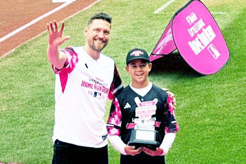 Hunter Pence presented the trophy to Ronin McCrea for winning the 2023 T-Mobile Little League Home Run Derby Championship.
