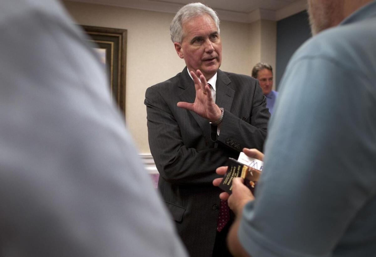 Rep. Tom McClintock (R-Elk Grove) talks with voters at a tea party group. Four Democrats and one Republican have filed to run against him.