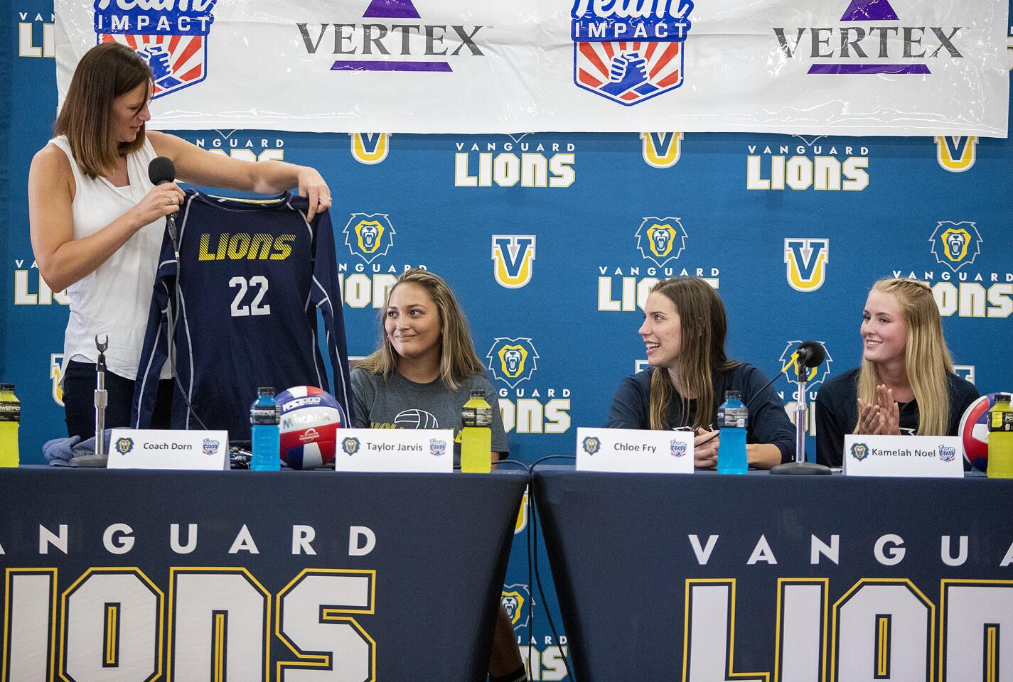 Vanguard University women's volleyball coach Jennifer Dorn presents Taylor Jarvis, 15, of Fountain Valley with a jersey during a "draft day" for her Thursday. Taylor, who has been living with Type 1 diabetes since she was a year old, is joining the team as an honorary member this school year.