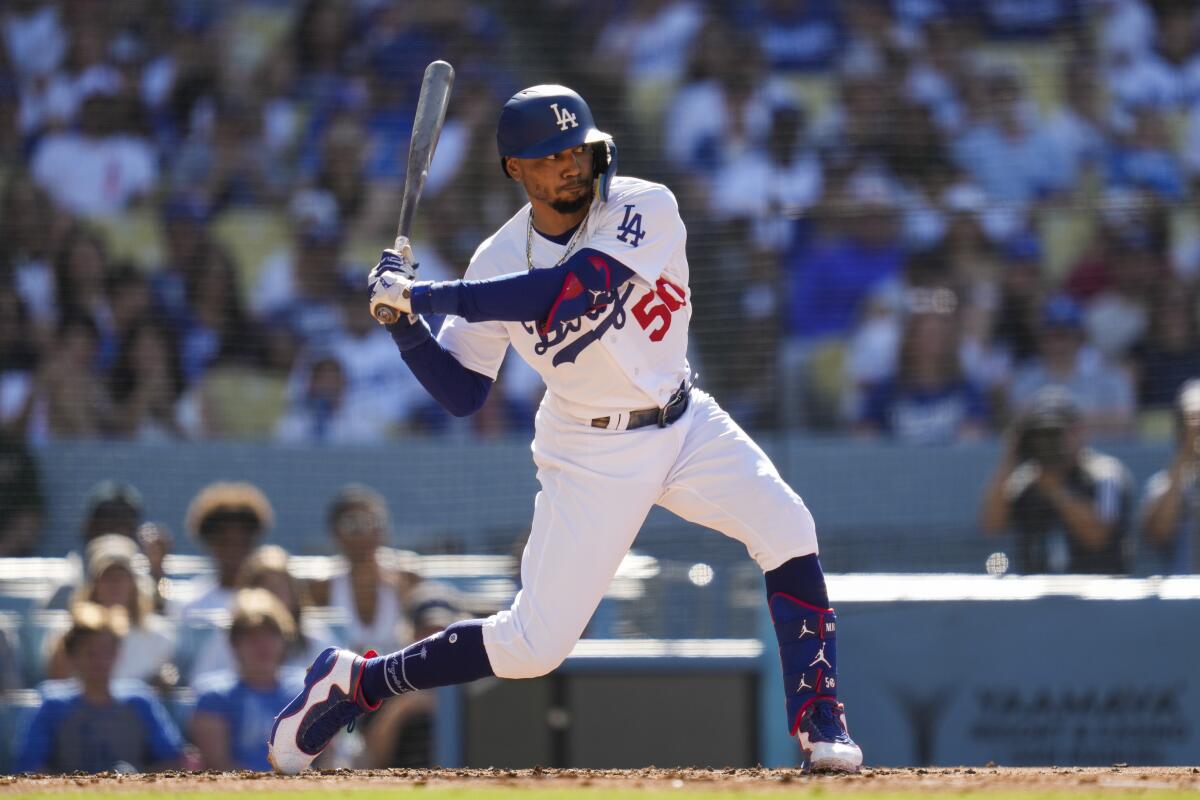 Dodgers star Mookie Betts swings at a pitch.