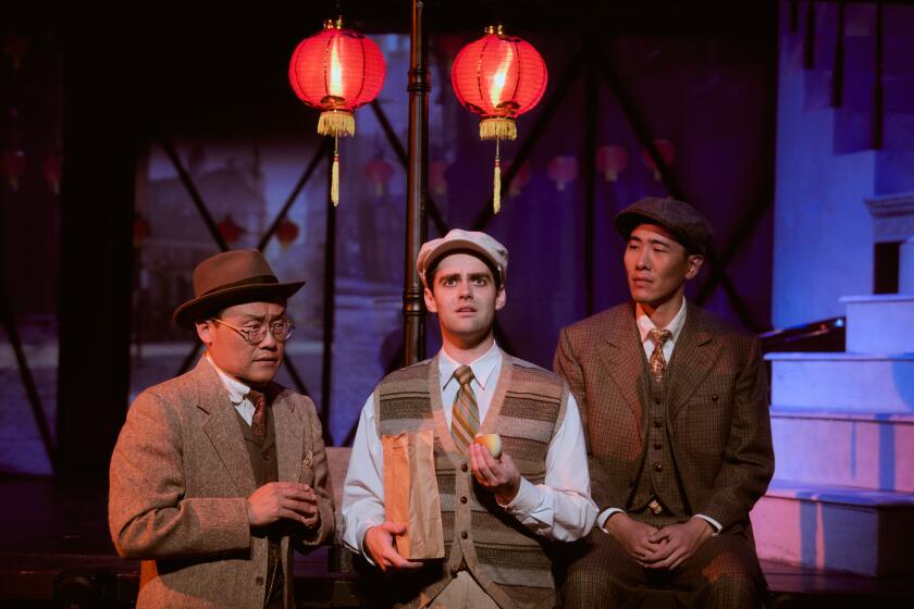 Three men gathered in front of Chinese lanterns