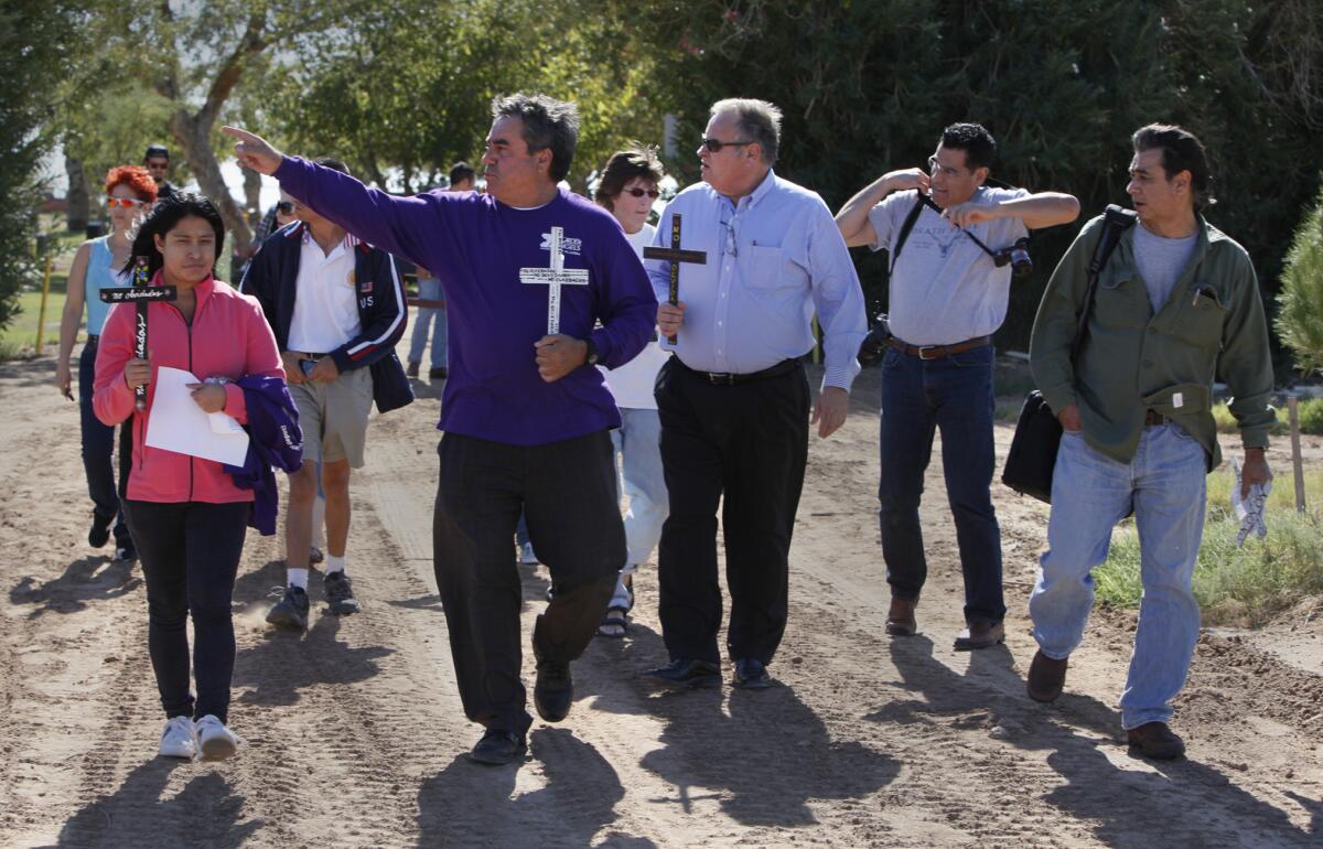 Enrique Morones, center left, leads a walk for the unnamed deceased migrants buried in pauper's graves