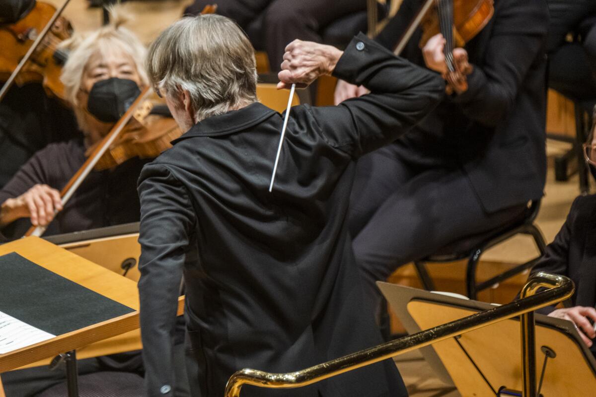 A man conducting an orchestra.