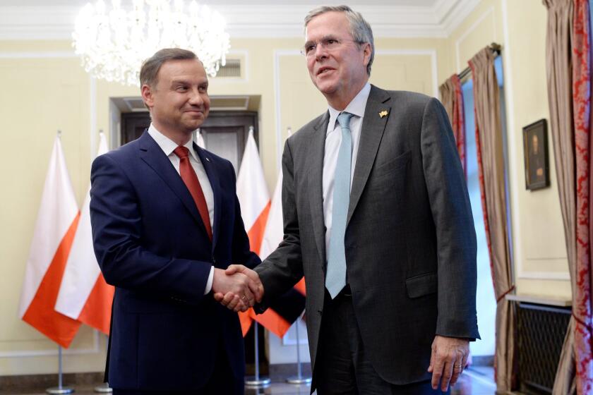 Polish President-elect Andrzej Duda, left, greets Jeb Bush in Warsaw on June 11.