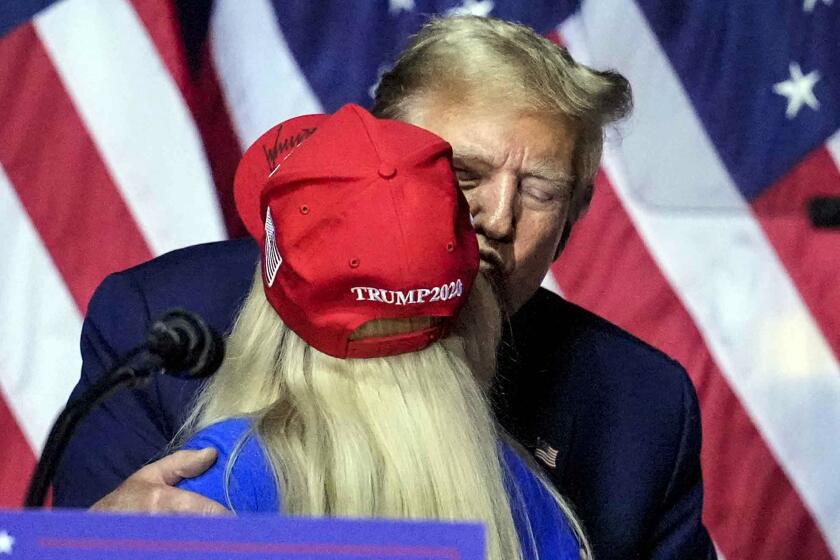 Republican presidential candidate former President Donald Trump kisses Rep. Marjorie Taylor Greene, R-Ga., as he speaks at a campaign rally Saturday, March 9, 2024, in Rome Ga. (AP Photo/Mike Stewart)