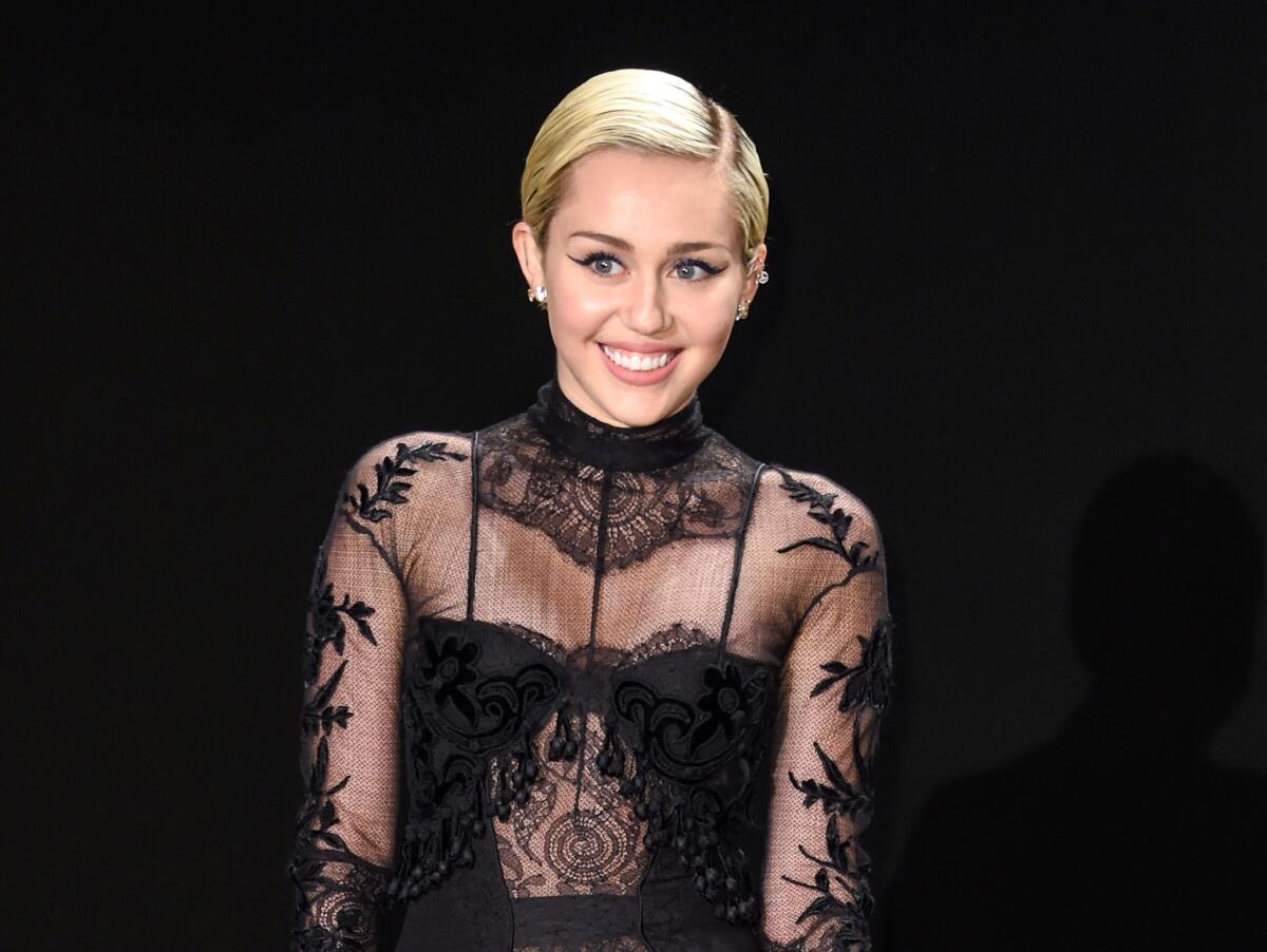 Miley Cyrus arrives at the Tom Ford autumn/winter 2015 womenswear presentation in Los Angeles on Feb. 20.