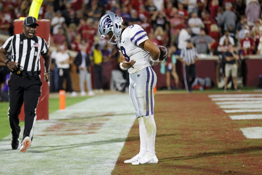 Kansas State quarterback Adrian Martinez (9) bows after scoring a touchdown against Oklahoma in the second half of an NCAA college football game, Saturday, Sept. 24, 2022, in Norman, Okla. (AP Photo/Nate Billings)