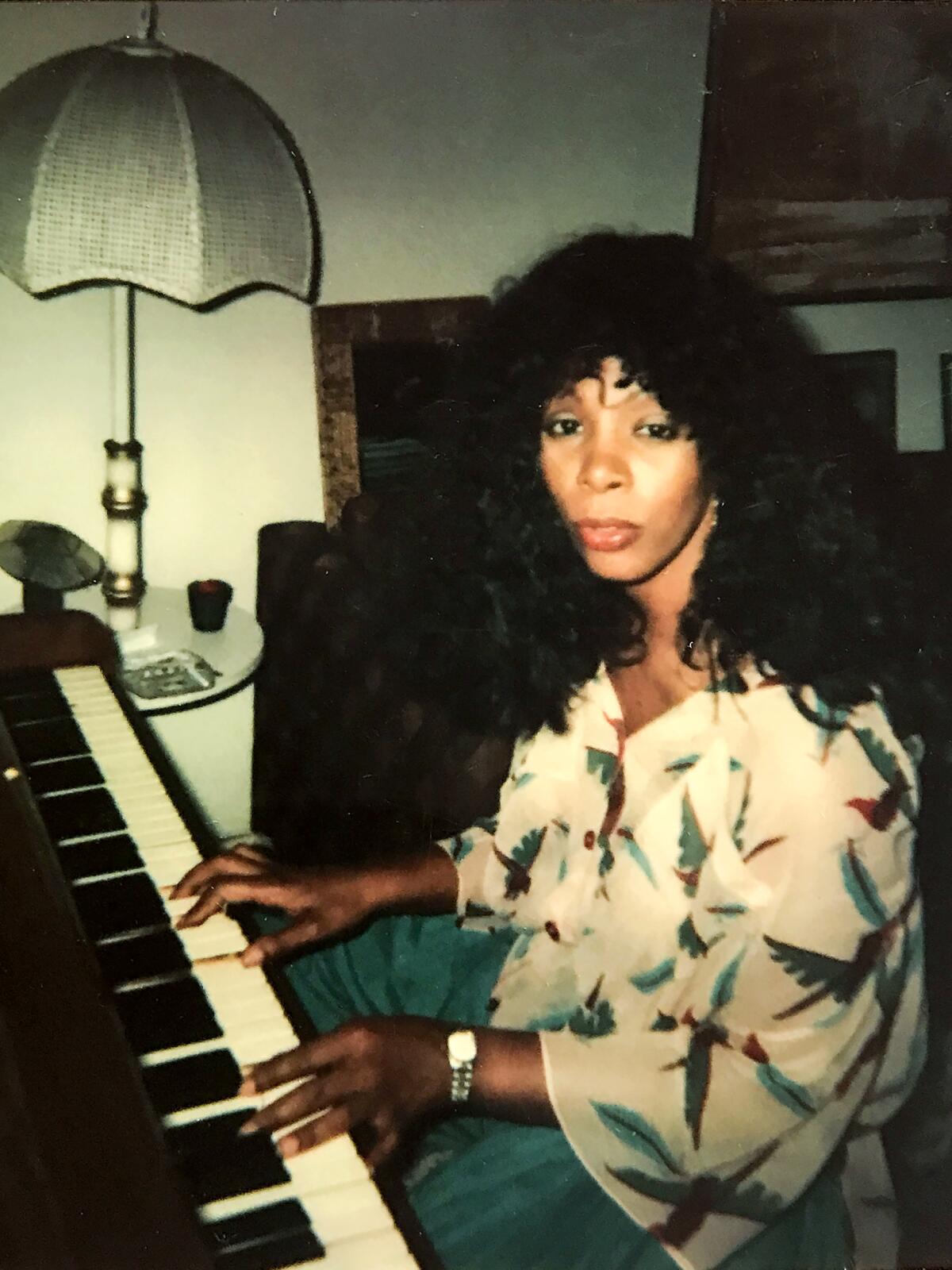 A woman playing the piano from the documentary "Love to Love You, Donna Summer."