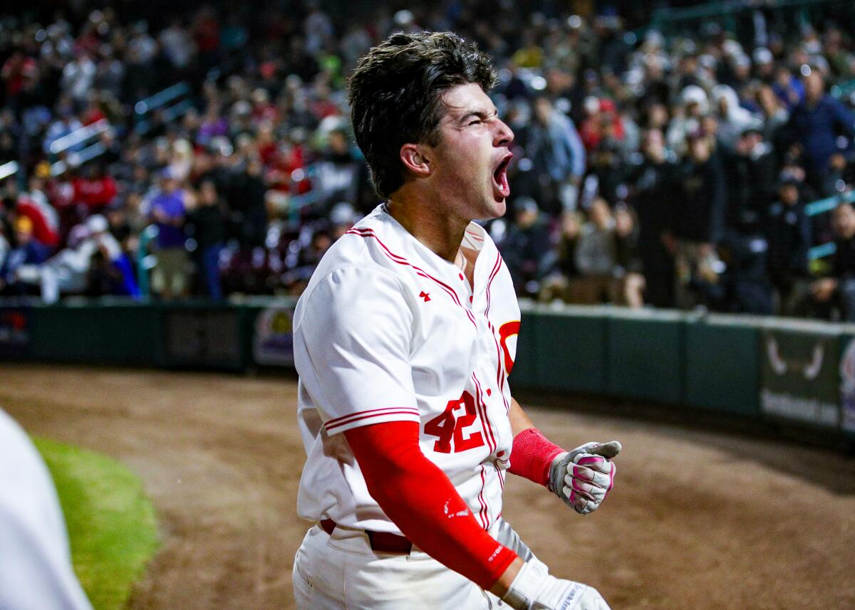 Corona High's Sam Burgess lets out a yell after hitting a three-run home run in the fourth inning against Harvard-Westlake.
