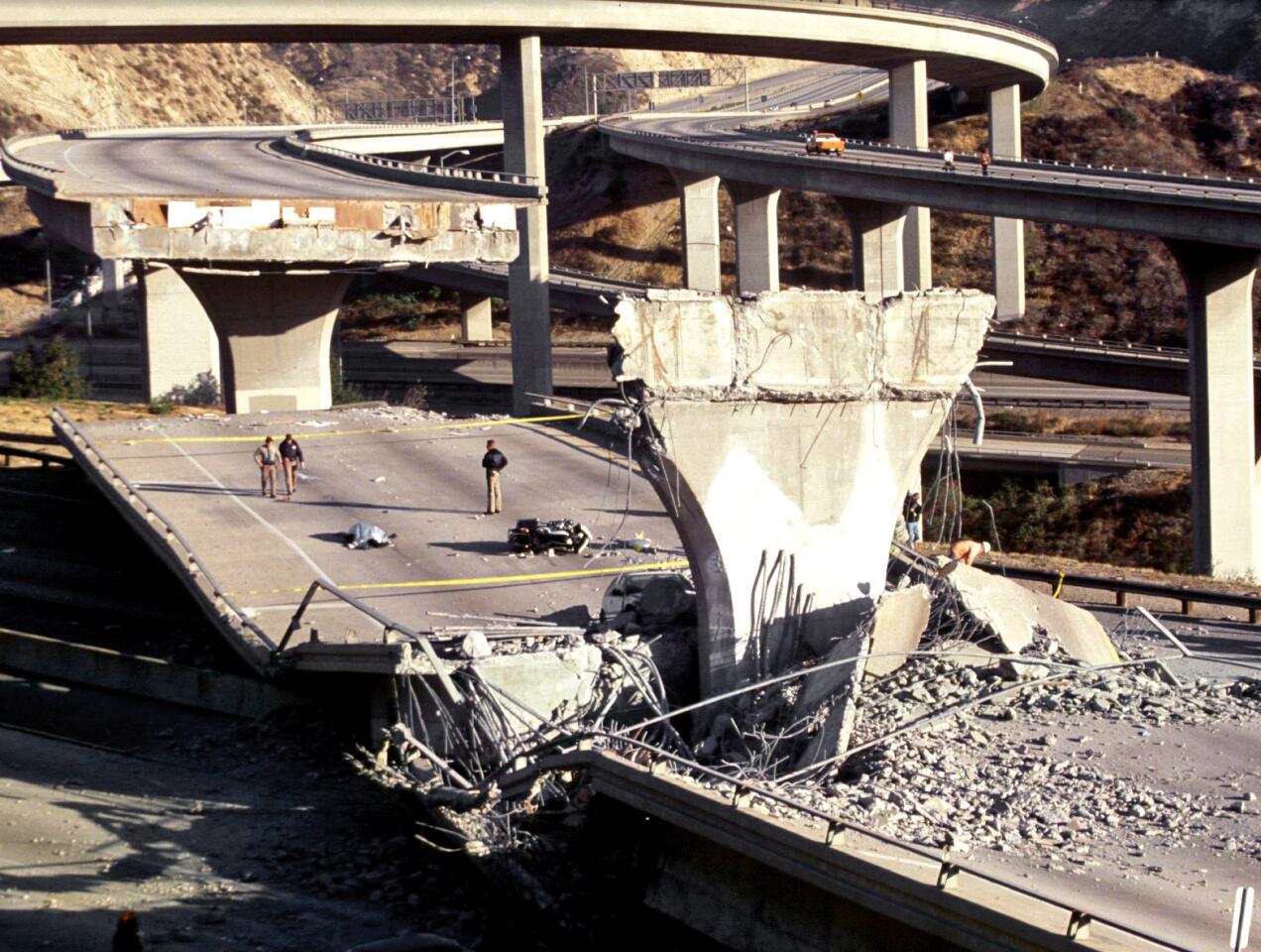 The body of Los Angeles Police Officer Clarence Wayne Dean lies near his motorcycle, which plunged off the 14 Freeway overpass that collapsed onto the 5 Freeway during the earthquake.