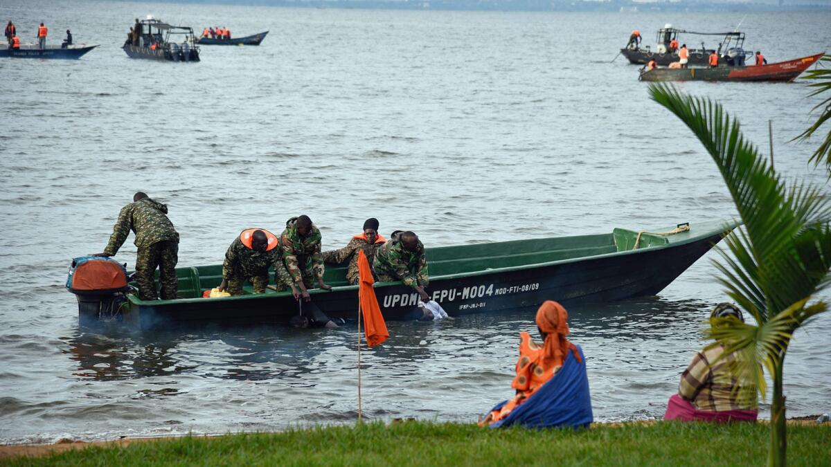 Ugandan navy crews collect bodies after a boat capsized on Lake Victoria at Mutima village, about 30 miles south of Kampala.